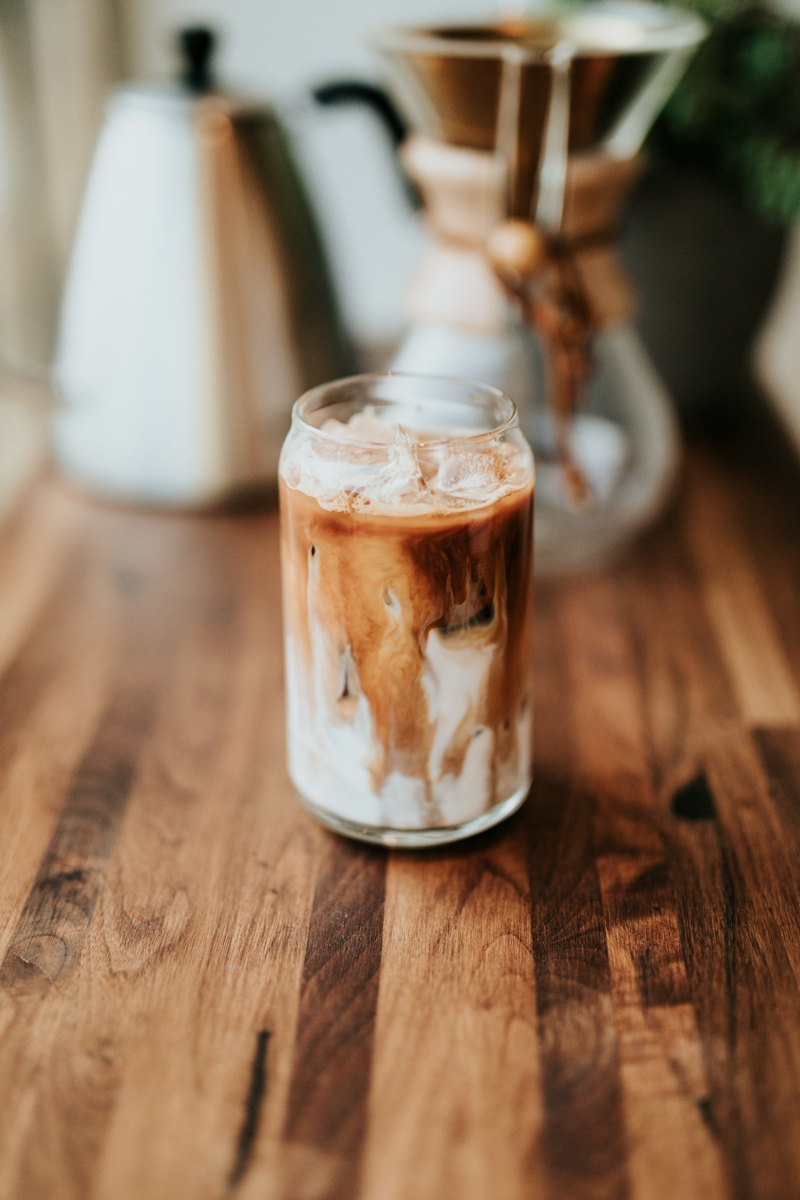 A cortado being poured, milk folding into crema.